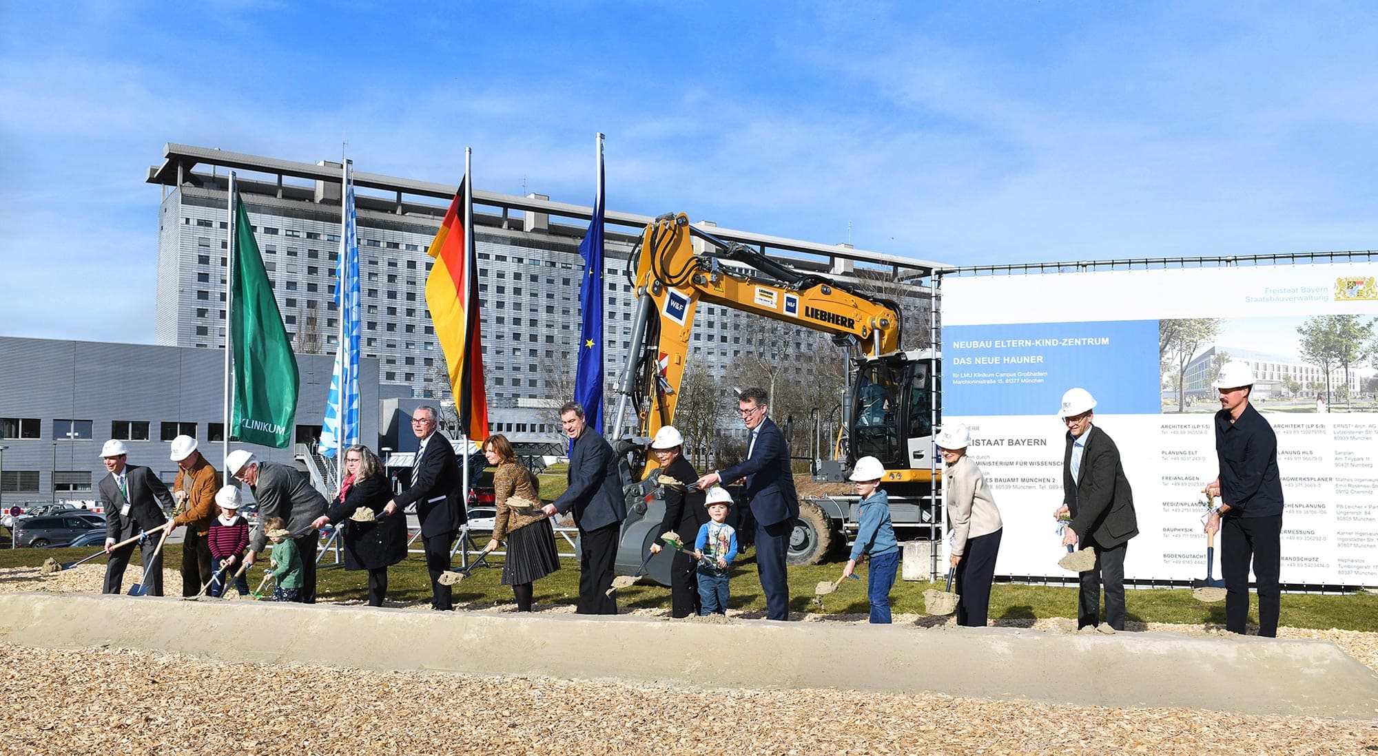 Ein Bild im Freien mit einer Gruppe von Menschen, die Spaten in der Hand halten